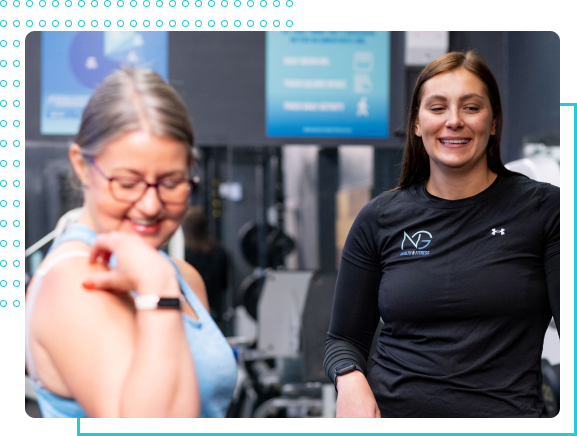 Paige laughing with a client at NG Health and Fitness